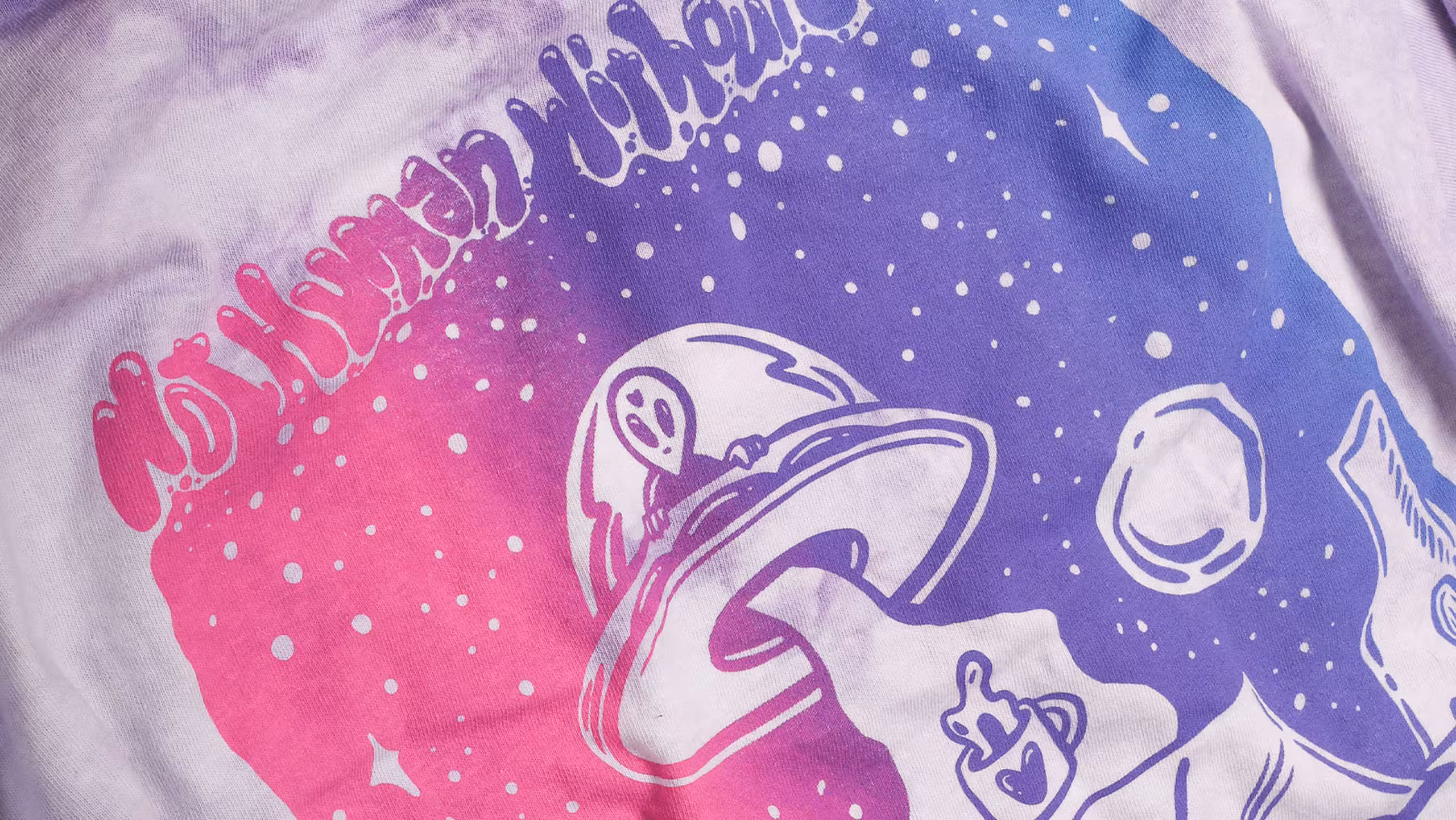 white shirt with a gradient printing with the colors pink to purple