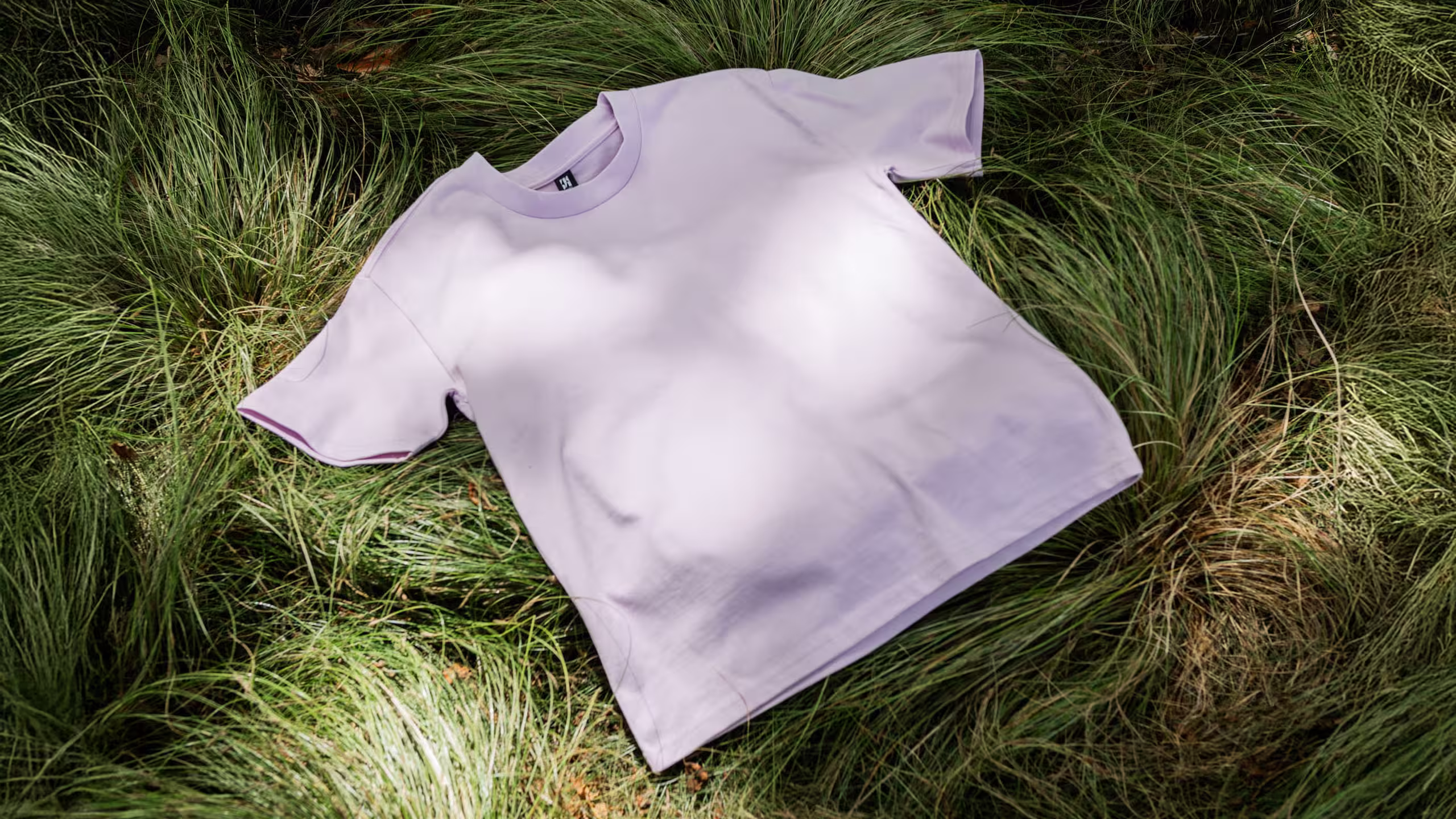orchid color tee on grass