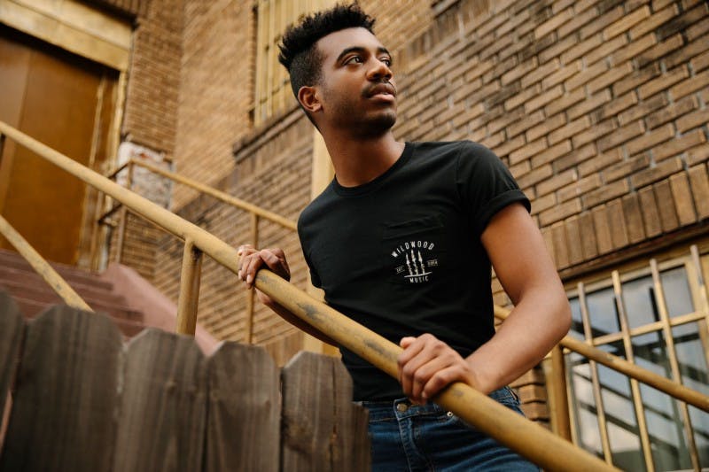 guy on stairs wearing a black screen printed t-shirt guy on stairs wearing a black screen printed t-shirt